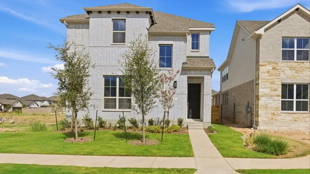 Front exterior of a new home in Flora, Hutto, TX, highlighting curb appeal (Image 1). Front exterior of a new home in Flora, Hutto, TX, highlighting curb appeal (Image 1).