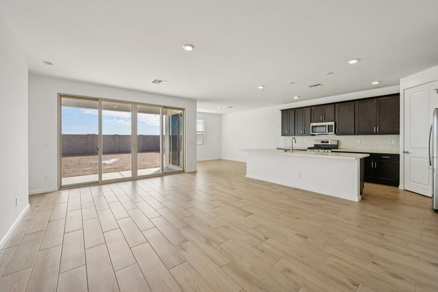 Great room, kitchen and dining. Finishes and options may vary by community