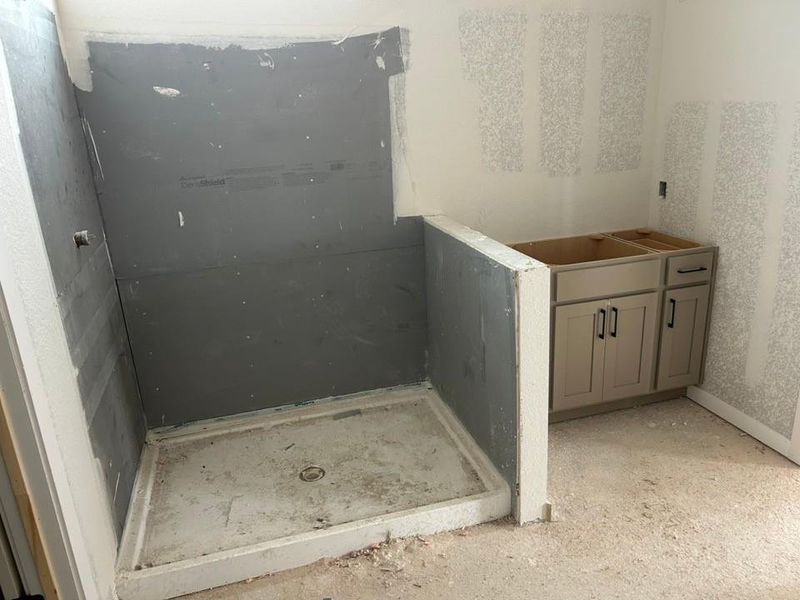 Full bath featuring a stall shower and vanity