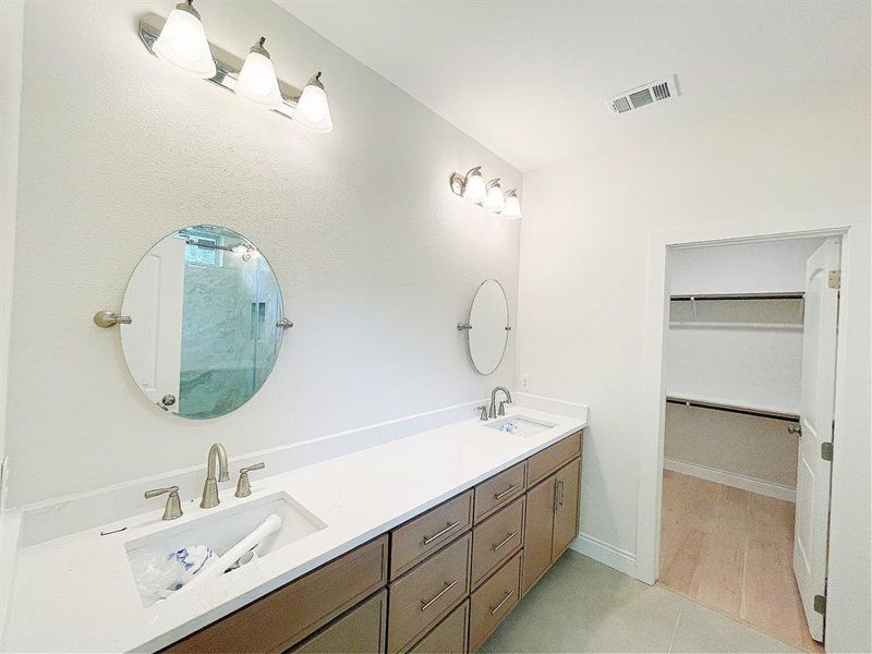 Double vanity with natural wood cabinets