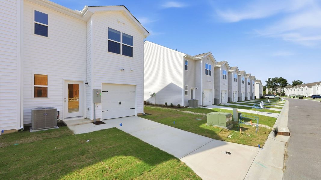 Front exterior of a new home in Clock Road Townhomes, New Bern, NC, highlighting curb appeal (Image 23). Front exterior of a new home in Clock Road Townhomes, New Bern, NC, highlighting curb appeal (Image 23).