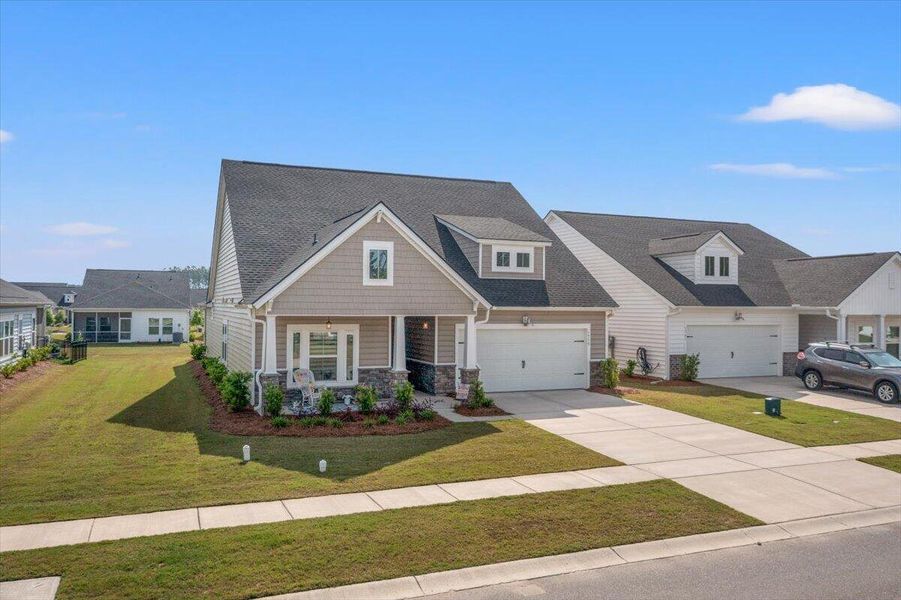 Front exterior of a new home in Horizons at Summers Corner | 55+, Summerville, SC, highlighting curb appeal (Image 23).