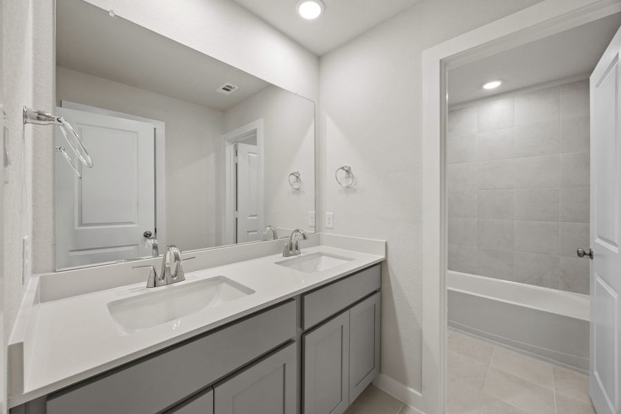 A bathroom with a sink and a shower unit. A bathroom with a sink and a shower unit.