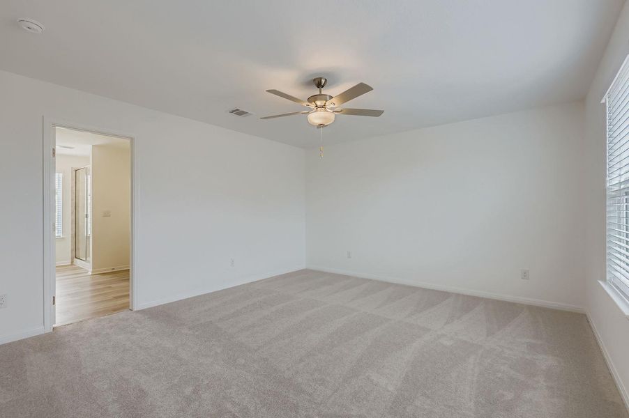 Spare room with light carpet and a ceiling fan Spare room with light carpet and a ceiling fan