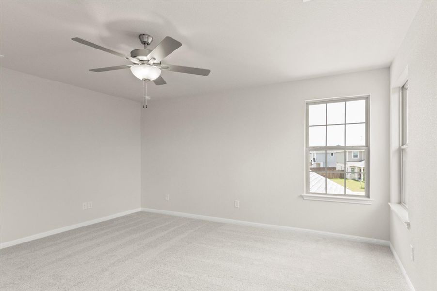 Unfurnished room with ceiling fan and light colored carpet
