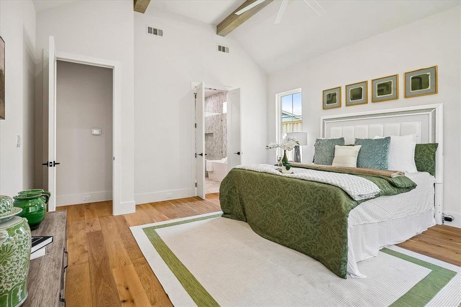 Primary suite, en suite bath entry, vaulted ceiling with exposed beams Primary suite, en suite bath entry, vaulted ceiling with exposed beams