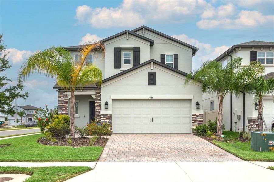 Front exterior of a new home in Cobblestone, Zephyrhills, FL, highlighting curb appeal (Image 1).