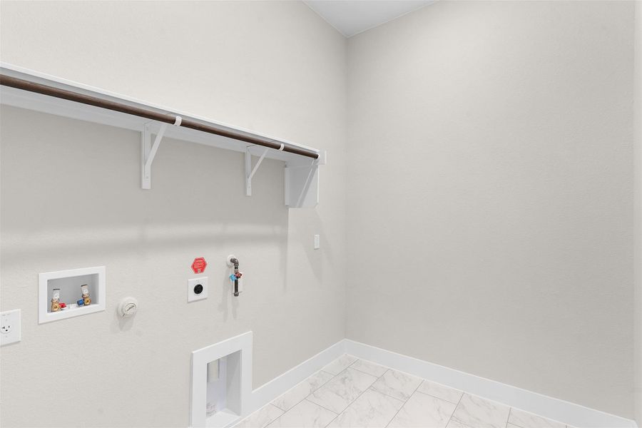 Washroom with hookup for a washing machine, light marble finish flooring, gas dryer hookup, and hookup for an electric dryer