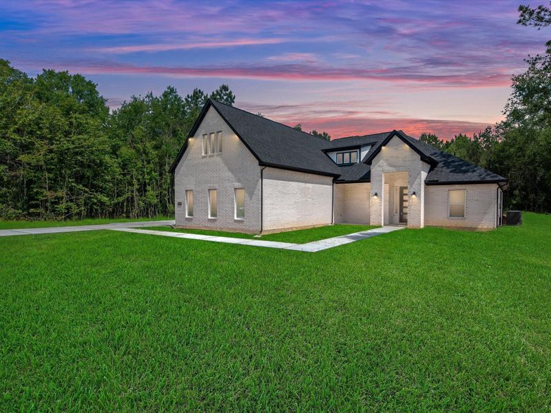 Front exterior of a new home in , Dayton, TX, highlighting curb appeal (Image 1).