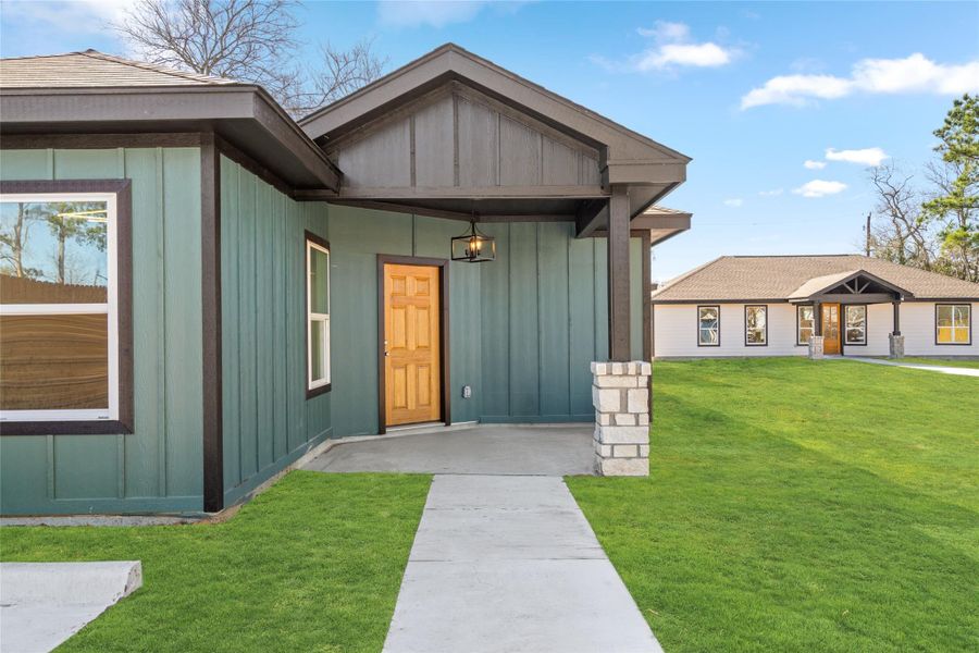 Inviting covered entry with stylish finishes and modern architectural detail.