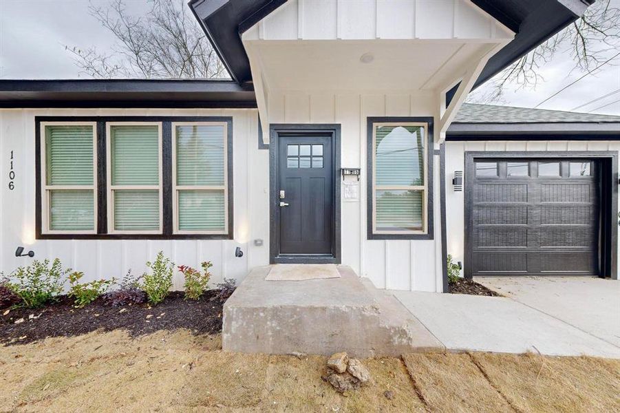 Doorway to property featuring a garage