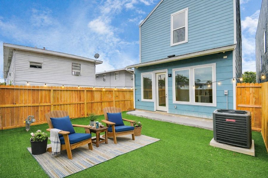 Private backyard with cozy seating area and low-maintenance turf. Perfect outdoor space for relaxing or entertaining.