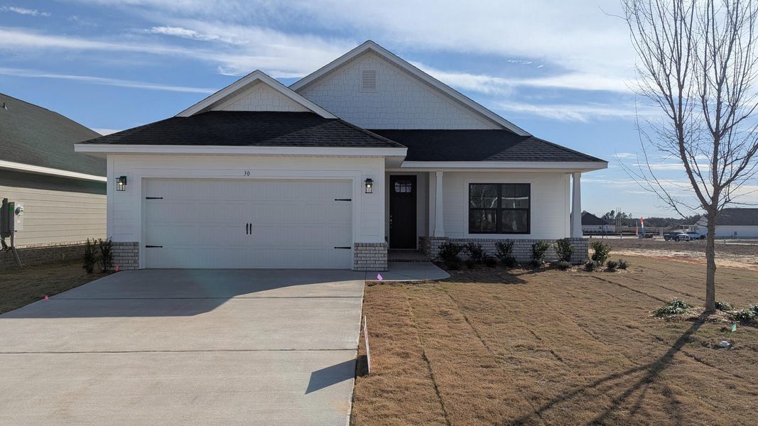 Front exterior of a new home in The Bluffs at Lafayette, Freeport, FL, highlighting curb appeal (Image 1).