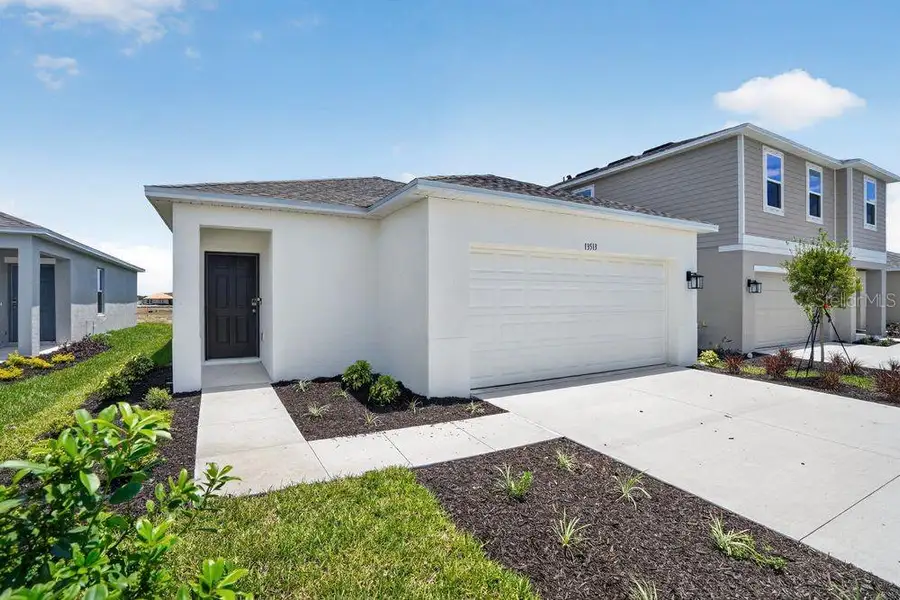 Front exterior of a new home in Firethorn, Parrish, FL, highlighting curb appeal (Image 17).