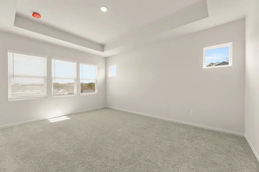 A room with a carpet and a window. A room with a carpet and a window.