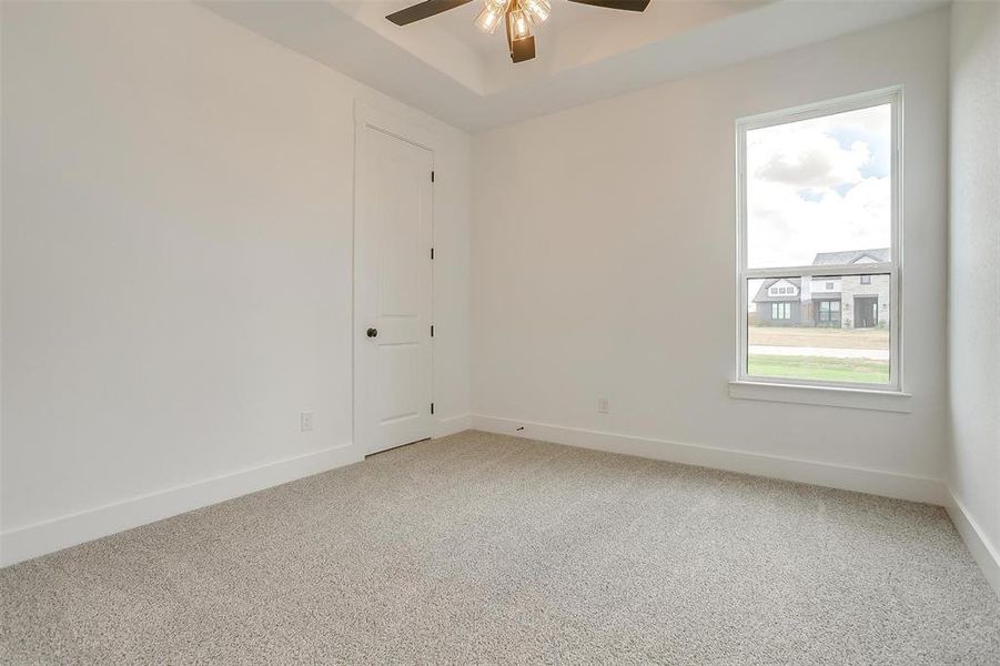 Spare room with ceiling fan and carpet