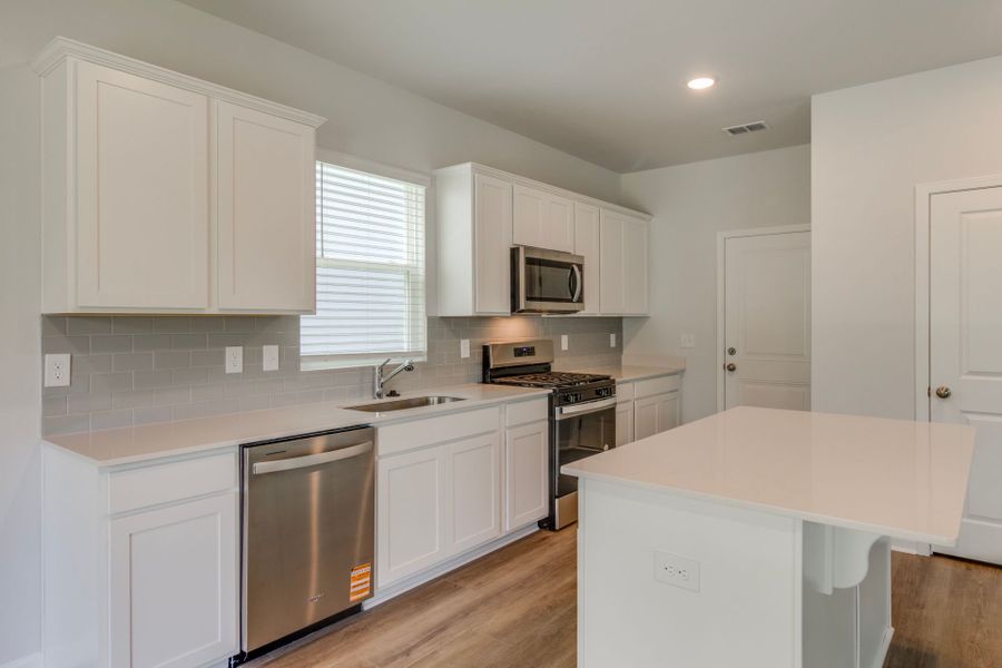 Longspur Kitchen with bright white cabinets.