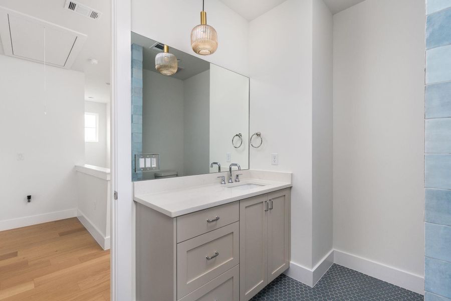 Bathroom featuring vanity and baseboards