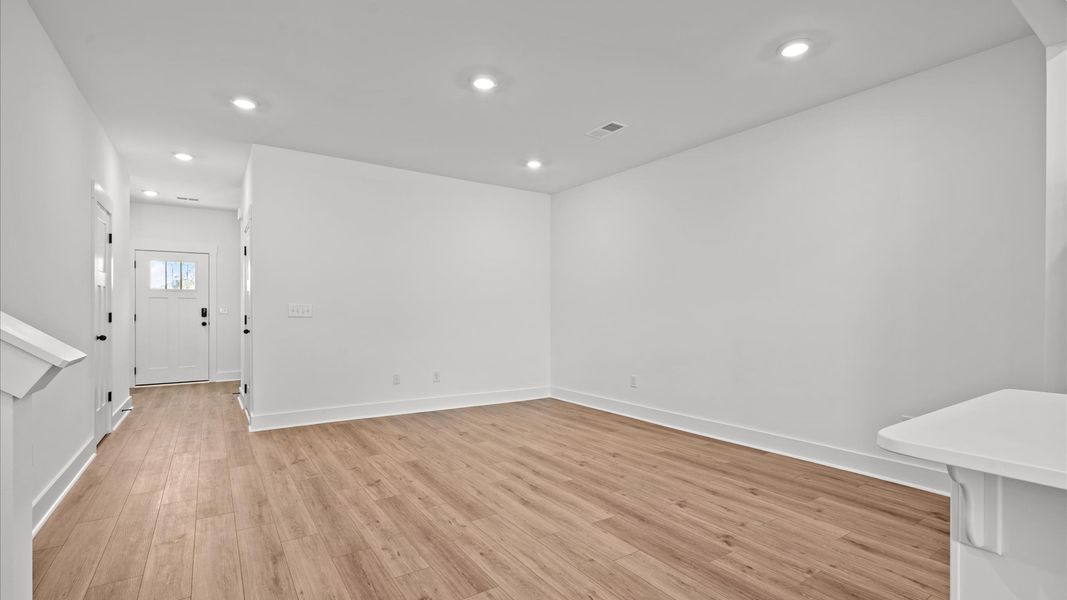 Vibrant and welcoming family room anchored by clean lines, tasteful materials, and abundant light