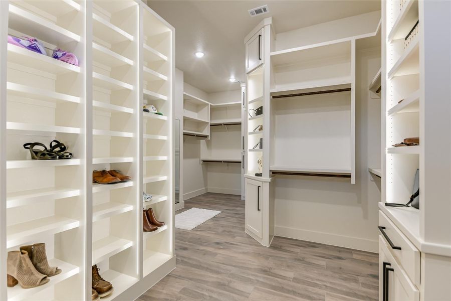 Walk in closet with shoe shelving Walk in closet with shoe shelving