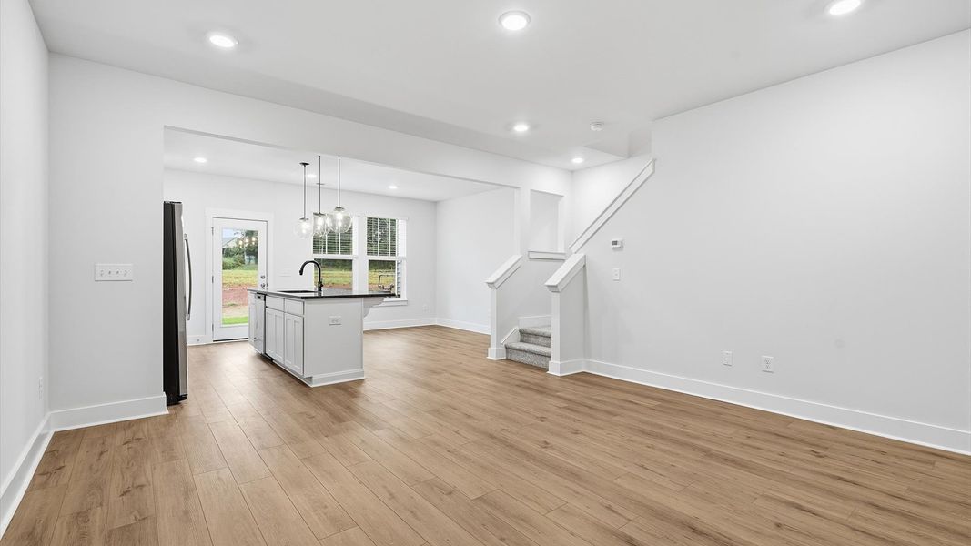 Exceptional family space with hardwood floors and seamless flow to dining and kitchen areas