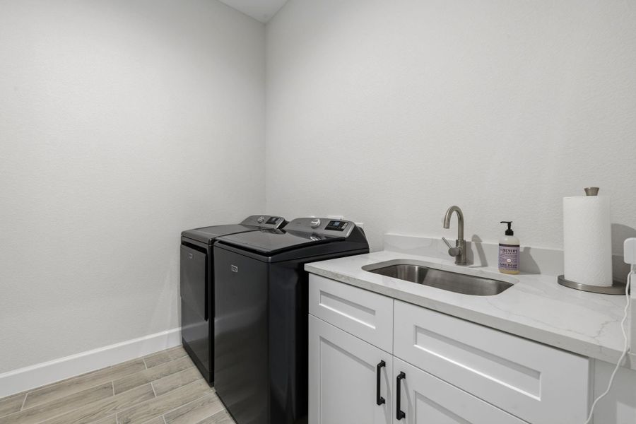UTILITY ROOM — Spacious utility room features utility sink for added functionality.