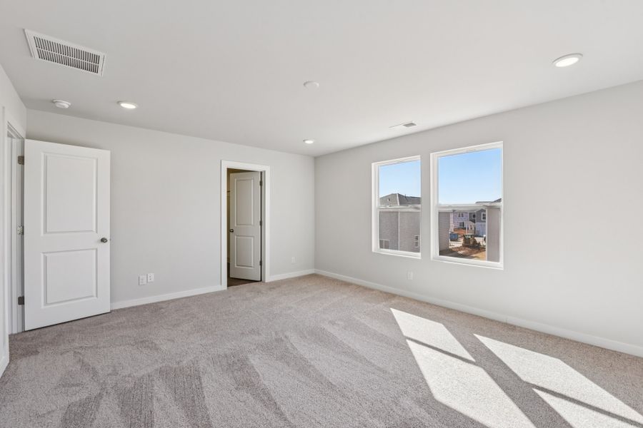 A room with white walls and a rug.