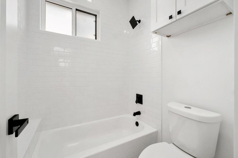 Bathroom featuring toilet and bathtub / shower combination