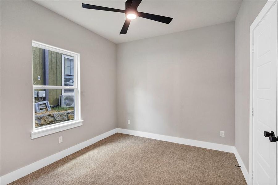 Spare room with carpet flooring and a ceiling fan
