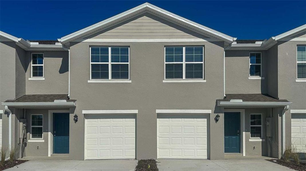 Front exterior of a new home in The Vineyards Townhomes, Daytona Beach, FL, highlighting curb appeal (Image 2).