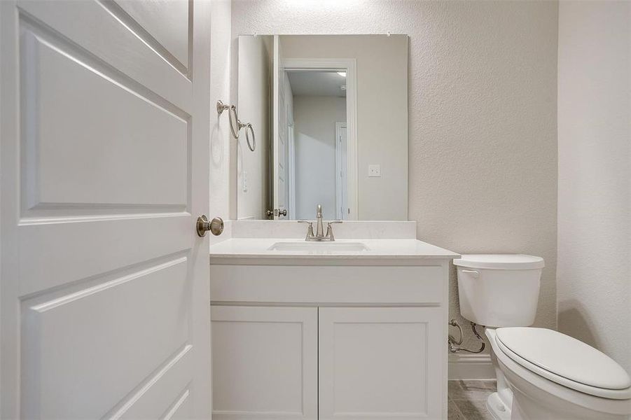 Bathroom featuring tile patterned floors, vanity, and toilet