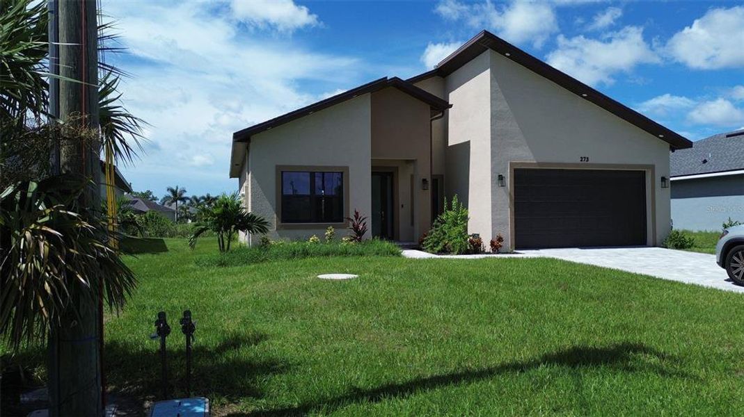 Front exterior of a new home in , Rotonda West, FL, highlighting curb appeal (Image 1).
