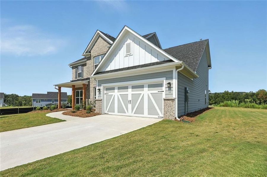 Front exterior of a new home in Berkeley Mill, Cumming, GA, highlighting curb appeal (Image 22). Front exterior of a new home in Berkeley Mill, Cumming, GA, highlighting curb appeal (Image 22).