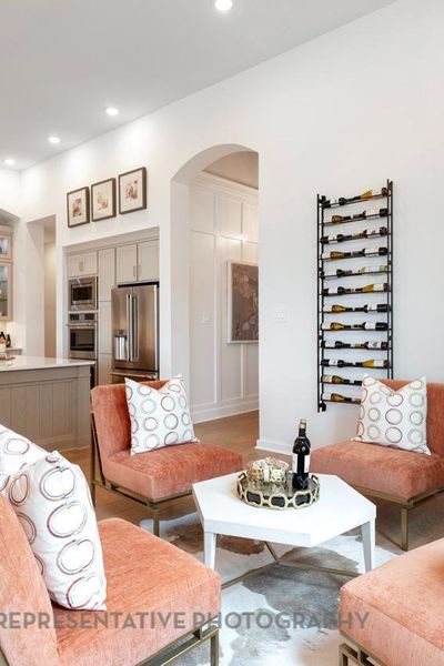 Living area with arched walkways and recessed lighting Living area with arched walkways and recessed lighting