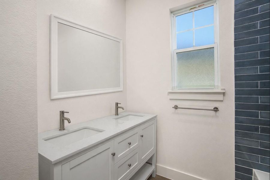 Double vanities in the en suite bathroom (mirror added virtually)