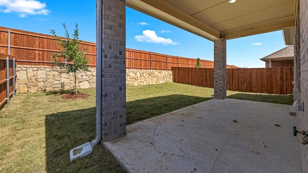 Fenced backyard featuring a patio