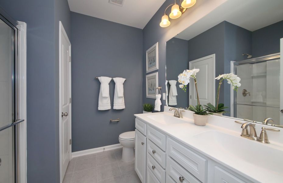 The Owner's Bathroom features dual-vanity sinks, a shower, and water closet