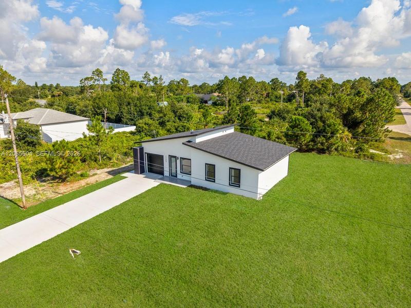 Front exterior of a new home in , Lehigh Acres, FL, highlighting curb appeal (Image 2). Front exterior of a new home in , Lehigh Acres, FL, highlighting curb appeal (Image 2).