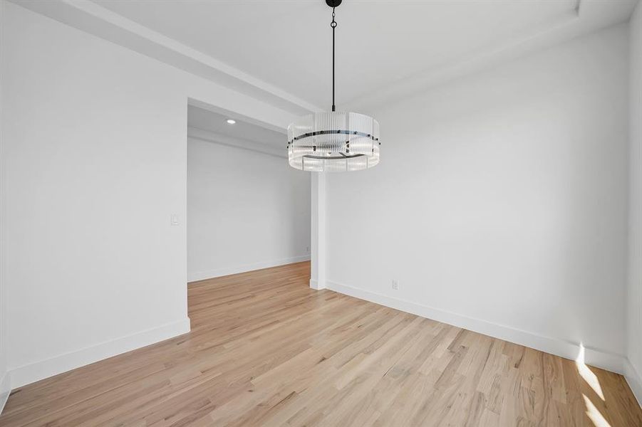 Unfurnished dining area featuring light wood finished floors and recessed lighting