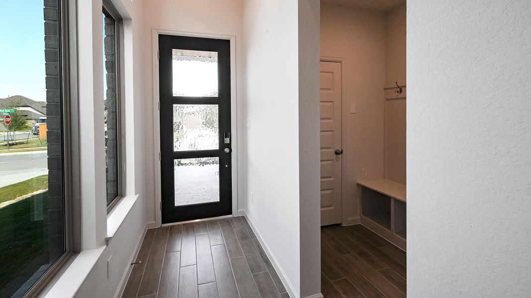 Doorway featuring wood finish floors and baseboards