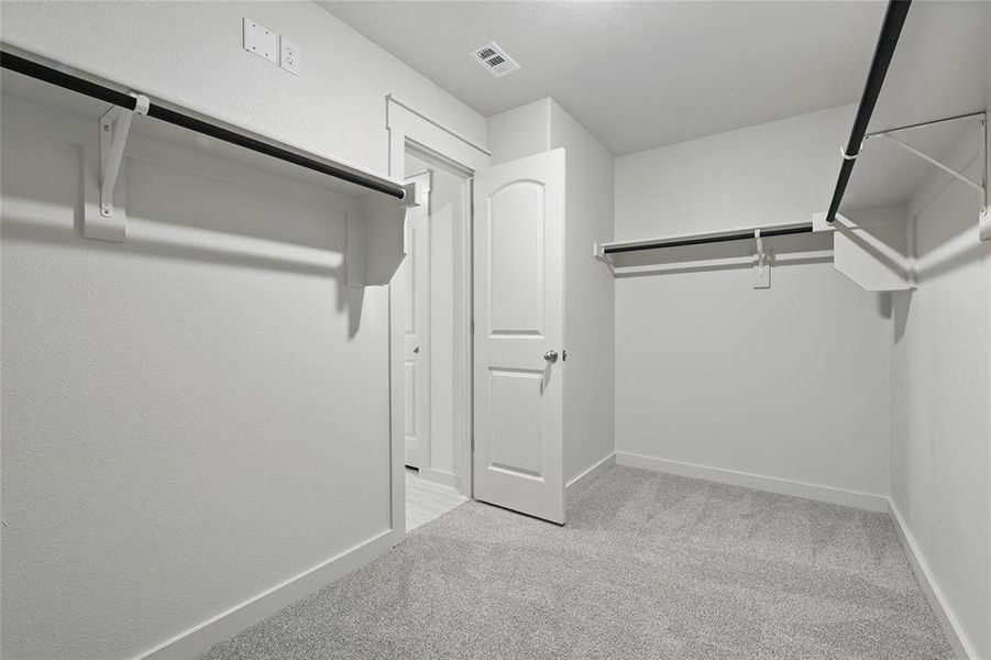Walk in closet with light carpet Walk in closet with light carpet