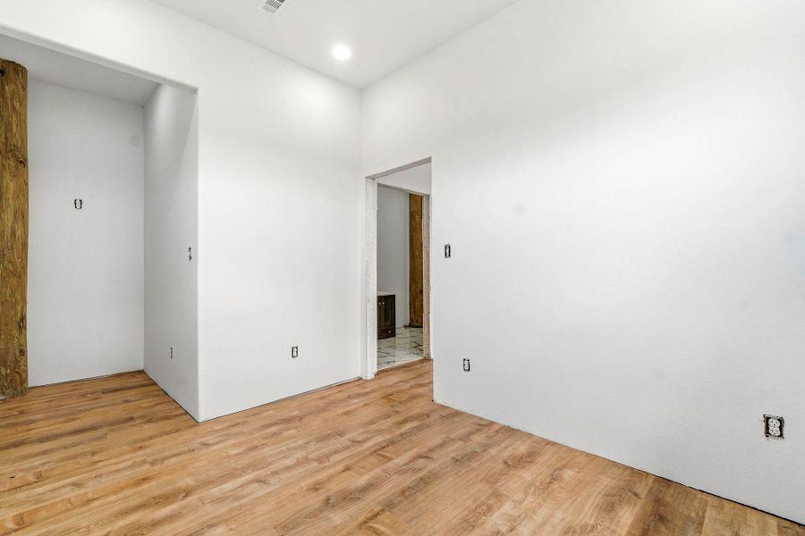 Massive walk-in closet off of the primary bedroom with ample space for vanity and built-ins.