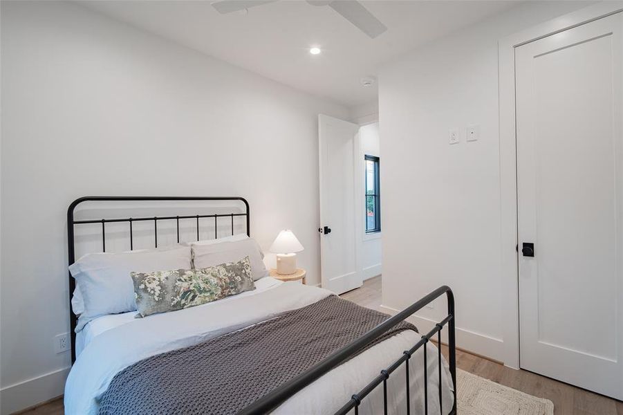 Bedroom with ceiling fan and light wood-type flooring