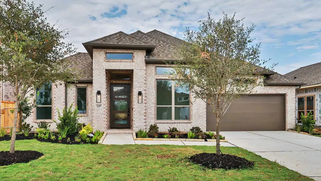 Front exterior of a new home in Lakes of Cane Island, Katy, TX, highlighting curb appeal (Image 1). Front exterior of a new home in Lakes of Cane Island, Katy, TX, highlighting curb appeal (Image 1).