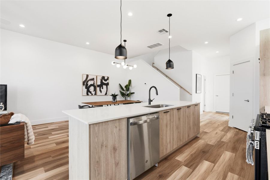 The kitchen opens directly to the dining and living areas, creating an easy, social layout for everyday living and entertaining.