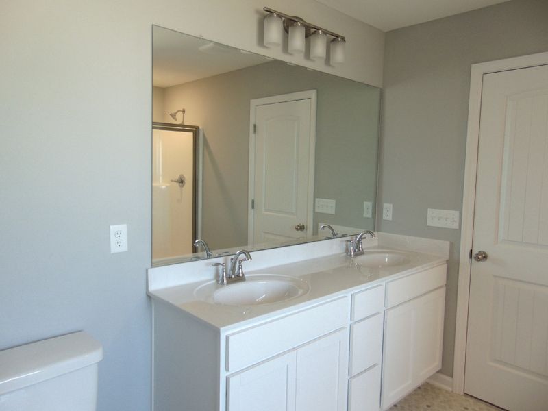 The primary bath includes a modern soaking tub for relaxation, and a shower. As well as two sinks, an elongated toilet, and your spacious closet.