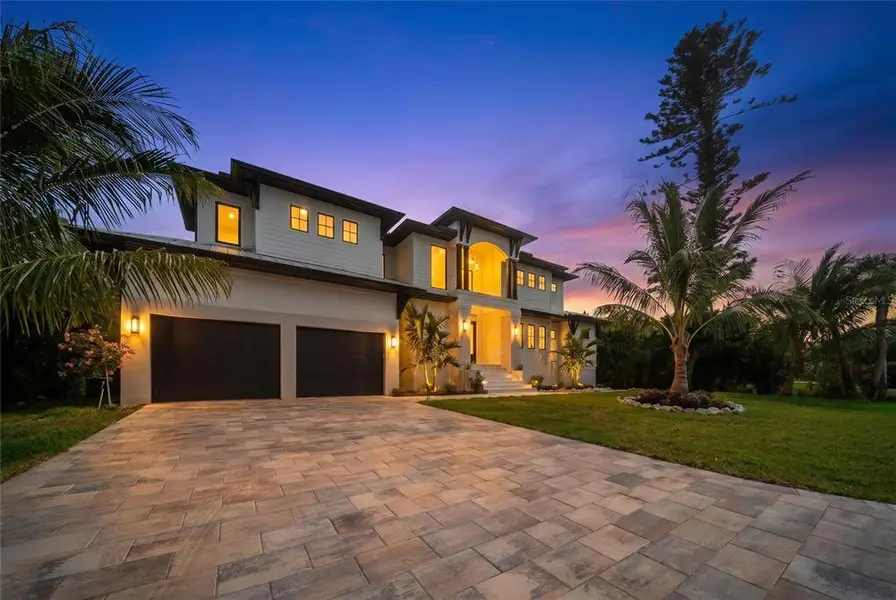 Front exterior of a new home in , Longboat Key, FL, highlighting curb appeal (Image 2). Front exterior of a new home in , Longboat Key, FL, highlighting curb appeal (Image 2).