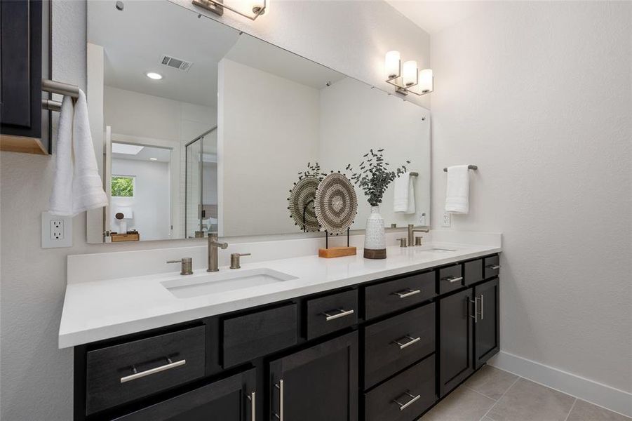 Stylish double vanity, providing ample space for two to unwind and prepare for the day ahead.