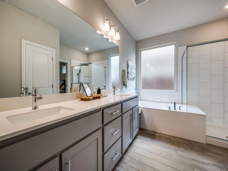 Spa-like primary bathroom with a large soaking tub and walk-in shower!