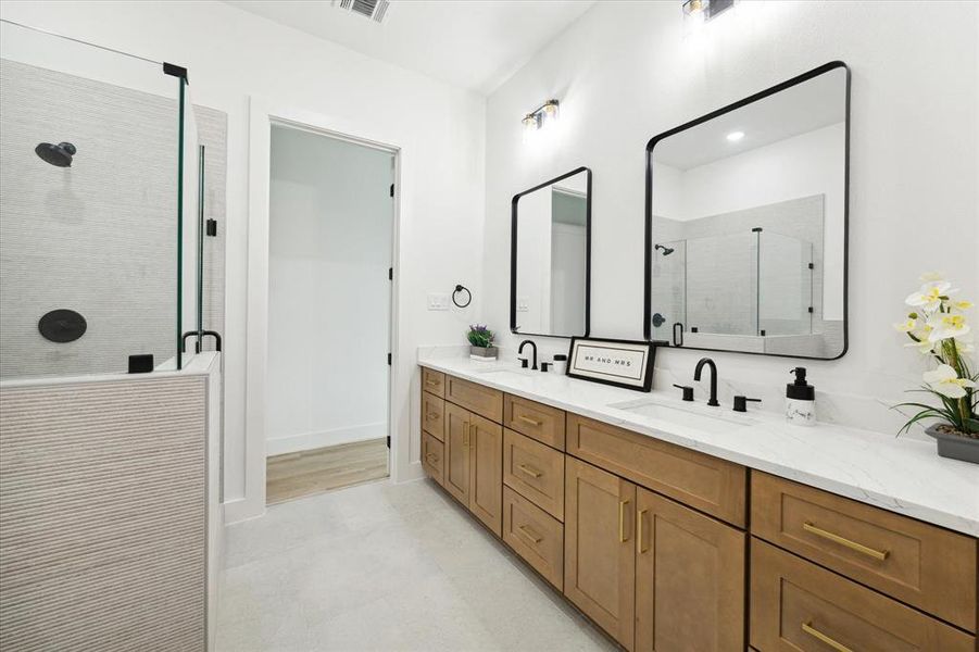 Alternate view of the primary bathroom dual sinks with spacious countertops, and storage.